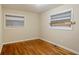Simple bedroom with hardwood floors and two windows at 1967 Glen Echo Dr, Decatur, GA 30032