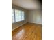 Spacious living room with hardwood floors and large window at 5470 Chanterella Sw Ct, Lilburn, GA 30047