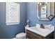 Elegant powder room with a modern vanity and blue walls at 571 Glen Eagles Se Cir, Marietta, GA 30067