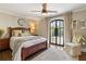 Bedroom with arched French doors leading to a balcony at 571 Glen Eagles Se Cir, Marietta, GA 30067