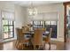 Bright dining room with a round wooden table and wicker chairs at 571 Glen Eagles Se Cir, Marietta, GA 30067