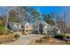 Stunning stone house with a large driveway and mature trees at 571 Glen Eagles Se Cir, Marietta, GA 30067