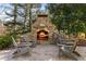 Outdoor stone fireplace with seating area at 571 Glen Eagles Se Cir, Marietta, GA 30067