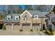 Three-car garage with gray doors and stone exterior at 571 Glen Eagles Se Cir, Marietta, GA 30067