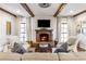 Cozy living room features a fireplace, exposed beams, and comfortable seating at 571 Glen Eagles Se Cir, Marietta, GA 30067