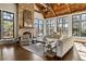 Sunlit living room with a stone fireplace and hardwood floors at 571 Glen Eagles Se Cir, Marietta, GA 30067