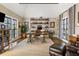 Home office with brick feature wall, built-in shelves, and hardwood floors at 571 Glen Eagles Se Cir, Marietta, GA 30067