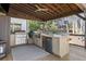 Outdoor kitchen with grill, refrigerator, and bar seating at 571 Glen Eagles Se Cir, Marietta, GA 30067