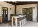 Covered patio with whitewashed brick walls and outdoor seating at 571 Glen Eagles Se Cir, Marietta, GA 30067