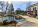Luxury pool with spa and firepit; expansive patio with lounge seating at 571 Glen Eagles Se Cir, Marietta, GA 30067
