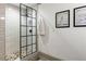 Walk-in shower with black frame and pebble floor at 571 Glen Eagles Se Cir, Marietta, GA 30067