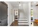 Elegant staircase with a dark wood railing and tile flooring at 571 Glen Eagles Se Cir, Marietta, GA 30067