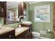 Modern bathroom with dark brown vanity, shower, and granite countertop at 156 Main St, Lilburn, GA 30047