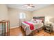 Well-lit bedroom with ceiling fan and hardwood floors at 156 Main St, Lilburn, GA 30047