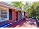 Inviting front porch with red door and American flag at 156 Main St, Lilburn, GA 30047