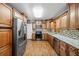 Modern kitchen with granite countertops and wood cabinets at 156 Main St, Lilburn, GA 30047