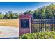 Entrance to a park with a brick pillar and wrought iron fence at 156 Main St, Lilburn, GA 30047