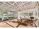 Relaxing screened porch with wicker furniture and wood floors at 156 Main St, Lilburn, GA 30047