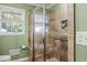 Updated shower with tiled walls and a built-in seat at 156 Main St, Lilburn, GA 30047