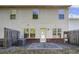 View of the backyard showing the house exterior and concrete patio, with some green space and fenced perimeter at 177 Oakland Hills Way, Lawrenceville, GA 30044