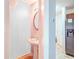 Cozy bathroom with pedestal sink and decorative mirror at 177 Oakland Hills Way, Lawrenceville, GA 30044