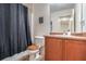 Well-lit bathroom with tub shower, vanity, and toilet at 177 Oakland Hills Way, Lawrenceville, GA 30044