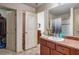 Functional bathroom featuring neutral flooring, vanity with countertop, and open doorway to the toilet and shower at 177 Oakland Hills Way, Lawrenceville, GA 30044