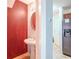 Powder room featuring pedestal sink and bright lighting adjacent to kitchen area at 177 Oakland Hills Way, Lawrenceville, GA 30044