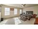 Spacious bedroom with natural light, ceiling fan, carpeted floor, and neutral walls at 177 Oakland Hills Way, Lawrenceville, GA 30044