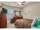 Cozy bedroom featuring a ceiling fan, natural light, and comfortable carpeting at 177 Oakland Hills Way, Lawrenceville, GA 30044