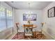 Bright dining area featuring decorative rug, chandelier, window, and a round table with chairs at 177 Oakland Hills Way, Lawrenceville, GA 30044