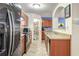 Well-equipped kitchen featuring stainless steel fridge, dark wood cabinets, and a walk-in pantry at 177 Oakland Hills Way, Lawrenceville, GA 30044