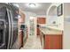 Functional kitchen with stainless steel fridge, dark wood cabinets, and a walk-in pantry at 177 Oakland Hills Way, Lawrenceville, GA 30044