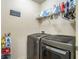 Convenient laundry room with washer, dryer, and shelving at 177 Oakland Hills Way, Lawrenceville, GA 30044