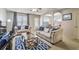 Comfortable living room featuring neutral decor, two sofas, a ceiling fan, and a decorative blue rug at 177 Oakland Hills Way, Lawrenceville, GA 30044