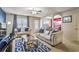 Inviting living room featuring neutral tones, ceiling fan, and an open floorplan to the adjacent dining area at 177 Oakland Hills Way, Lawrenceville, GA 30044