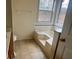 Bright bathroom with tub at 2800 Camelot Woods Dr, Lawrenceville, GA 30044