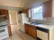 Kitchen featuring white appliances and wood cabinets at 2800 Camelot Woods Dr, Lawrenceville, GA 30044