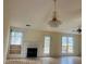 Bright living room featuring a fireplace and elegant chandelier at 2800 Camelot Woods Dr, Lawrenceville, GA 30044