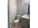 Updated bathroom with gray vanity and tiled floor at 3730 Oak Park Dr, Suwanee, GA 30024