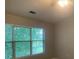 Spacious bedroom with large windows and ceiling fan at 3730 Oak Park Dr, Suwanee, GA 30024