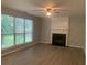 Living room with fireplace and large windows overlooking backyard at 3730 Oak Park Dr, Suwanee, GA 30024