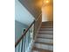 Wooden staircase with white railings leading to upper level at 3730 Oak Park Dr, Suwanee, GA 30024