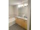 Modern bathroom with double vanity, granite countertop, and soaking tub at 390 17Th Street # 2002, Atlanta, GA 30363