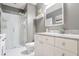 Modern bathroom with a large shower and granite vanity at 565 Peachtree Ne St # 1303, Atlanta, GA 30308