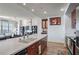 A modern kitchen flows to the living area, featuring stainless steel appliances and beautiful wood cabinets at 565 Peachtree Ne St # 1303, Atlanta, GA 30308