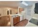 View of kitchen with wood cabinets and a breakfast bar at 713 Cypress Pointe St, Alpharetta, GA 30022