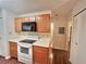 Bright kitchen featuring wood cabinets and white appliances at 713 Cypress Pointe St, Alpharetta, GA 30022