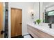 Modern bathroom with double vanity, a large mirror, and walk-in shower at 977 Fleetwood Cir, Atlanta, GA 30311