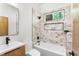 Modern bathroom with a bathtub, shower, and marble-style tile at 977 Fleetwood Cir, Atlanta, GA 30311